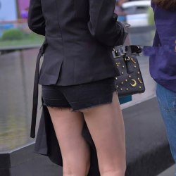 Brown-haired woman with a small ass in black short shorts 0