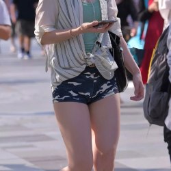 A girl in short camouflage shorts 0