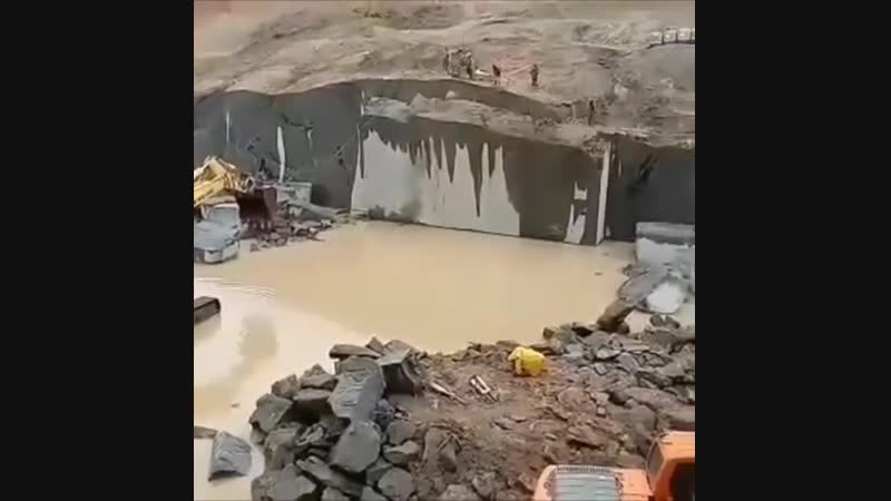 An excavator is knocking down a concrete wall. Video joke